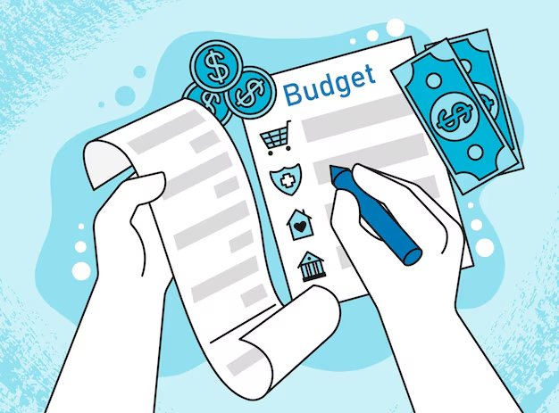 Hands writing on a budget plan with icons for shopping, healthcare, housing, and banking, surrounded by coins and cash.
